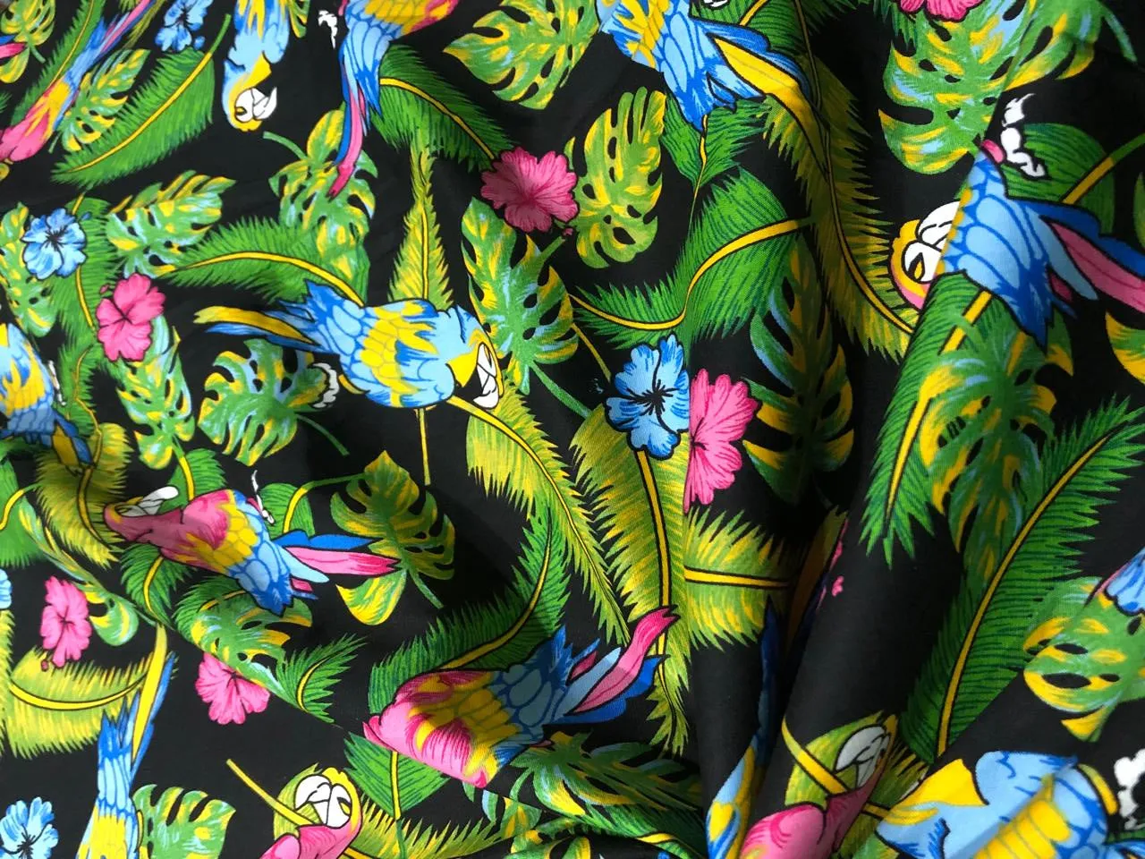 100% Cotton Poplin PRINT   58" wide RETRO BEACH available in 4 different prints pink ,orange, blue ,yellow ,green waves / black jungle with pink and blue parrots and flowers / blue with lavender pink flowers and black and white floral